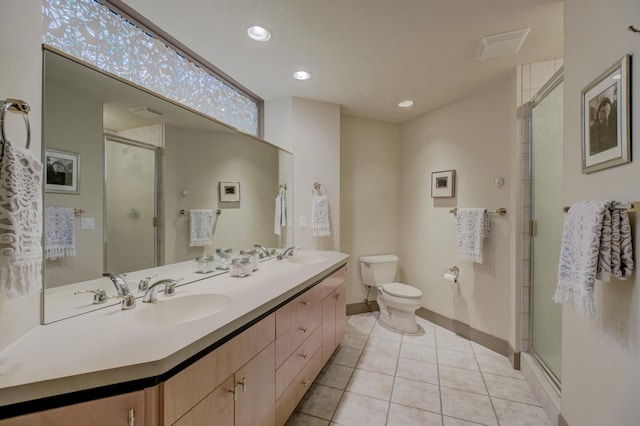 bathroom with tile patterned flooring, vanity, toilet, and a shower with shower door