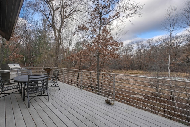 wooden terrace featuring a grill