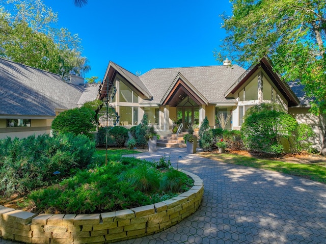 1 Capaul Woods Ct, North Oaks, MN 55127 - english style home with a chimney, stucco siding, and a shingled roof
