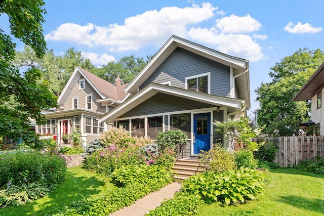 view of front of home featuring a front lawn and a sunroom