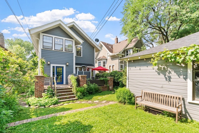 rear view of property with a yard