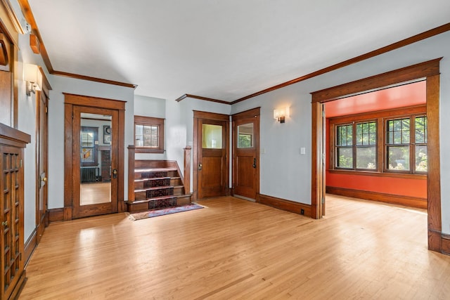 foyer with light hardwood / wood-style floors and ornamental molding