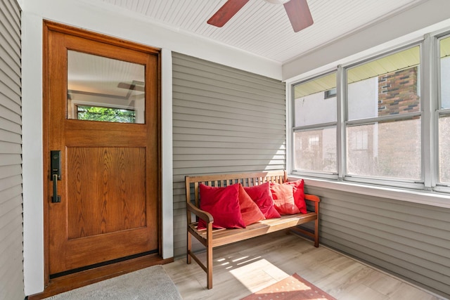 sunroom / solarium featuring ceiling fan and a wealth of natural light