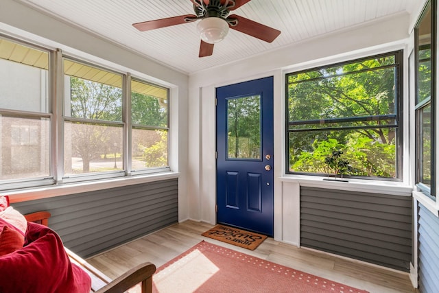 sunroom / solarium featuring ceiling fan and a healthy amount of sunlight