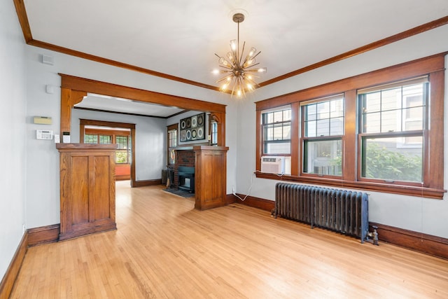 interior space featuring radiator heating unit, a chandelier, a wealth of natural light, and light wood-type flooring