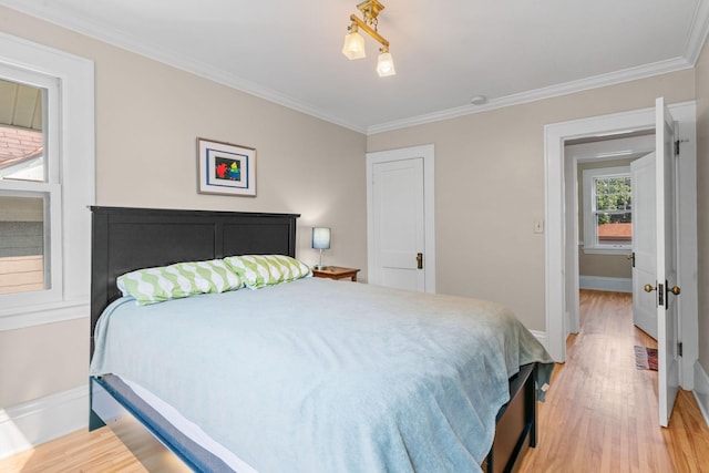 bedroom with light wood-type flooring and ornamental molding