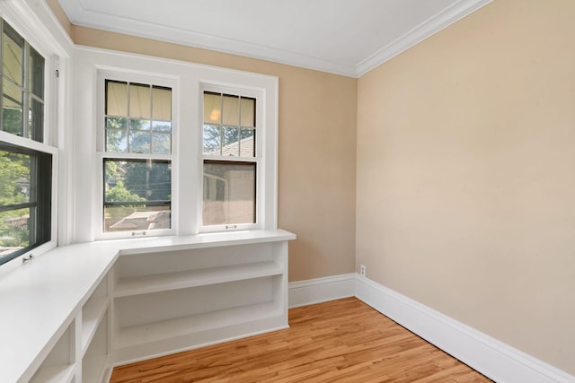 interior space featuring wood-type flooring and crown molding