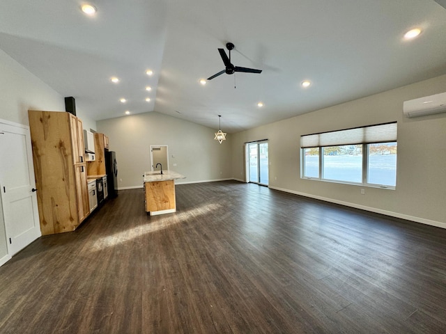 unfurnished living room with a wall mounted AC, dark hardwood / wood-style floors, vaulted ceiling, ceiling fan with notable chandelier, and sink