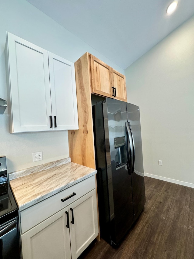 kitchen with dark wood-type flooring, white cabinetry, black electric range, and stainless steel fridge