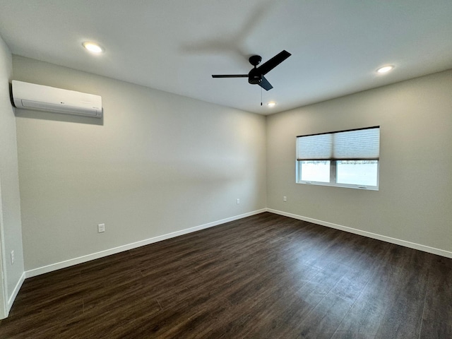 spare room with ceiling fan, dark hardwood / wood-style flooring, and a wall mounted AC