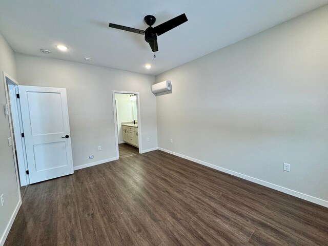 unfurnished bedroom with ceiling fan, dark hardwood / wood-style flooring, a wall mounted AC, and ensuite bath