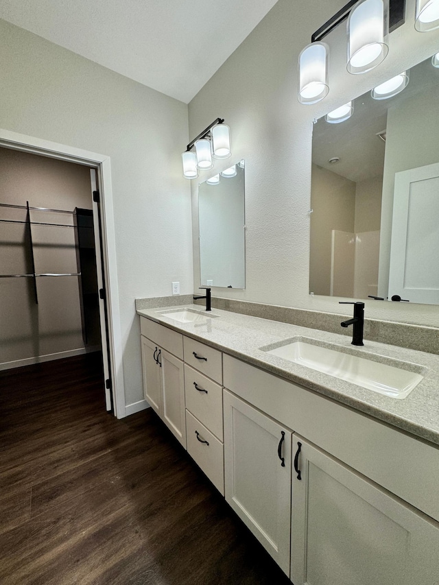 bathroom with vanity and hardwood / wood-style floors