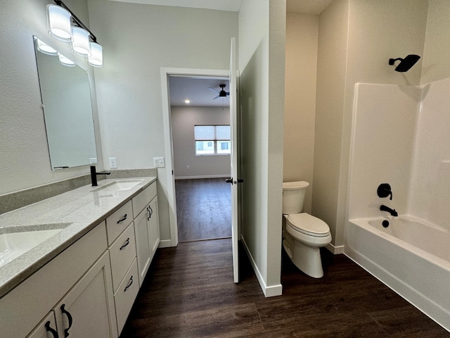 full bathroom featuring toilet, bathing tub / shower combination, and hardwood / wood-style flooring