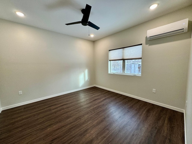 unfurnished room with ceiling fan, dark hardwood / wood-style flooring, and a wall mounted air conditioner