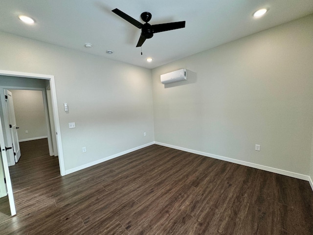 unfurnished room featuring ceiling fan, a wall mounted AC, and dark hardwood / wood-style floors