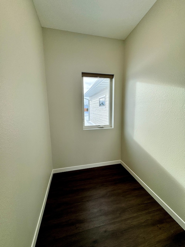 empty room with dark hardwood / wood-style floors