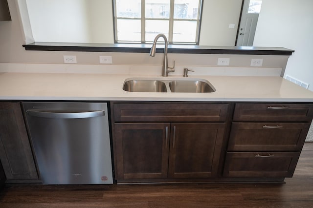 kitchen with dark brown cabinetry, sink, dark hardwood / wood-style flooring, and stainless steel dishwasher