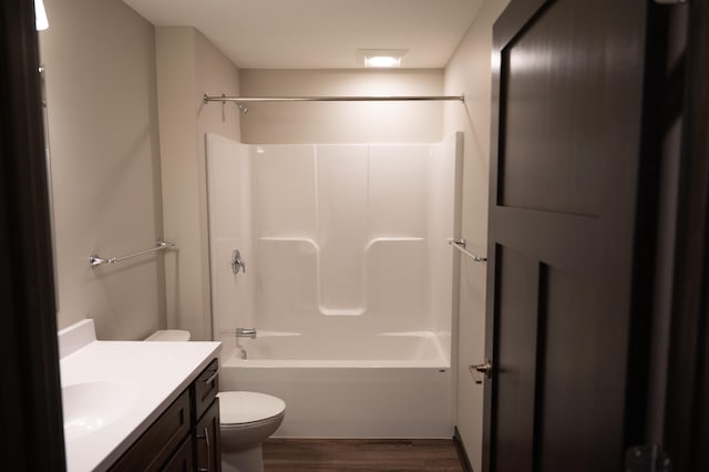 full bathroom with shower / tub combination, vanity, hardwood / wood-style floors, and toilet