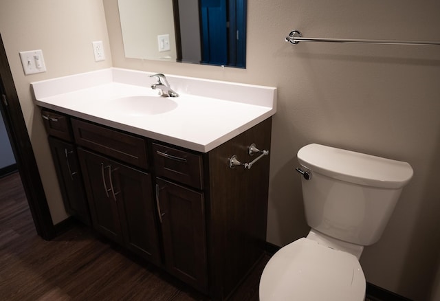 bathroom with vanity, wood-type flooring, and toilet