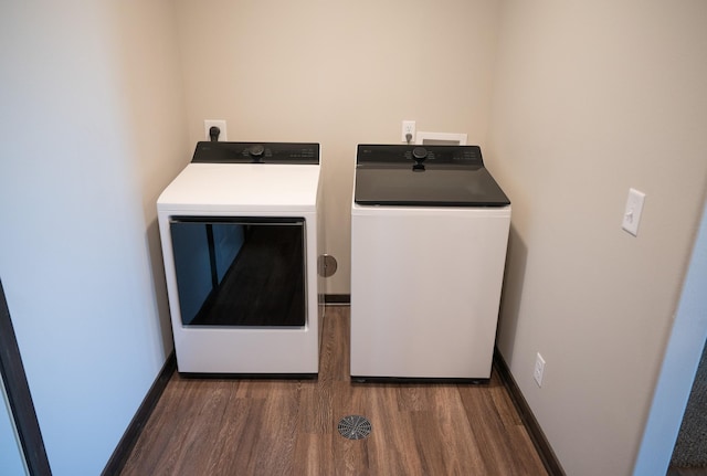 laundry area featuring dark wood-type flooring and washer and clothes dryer