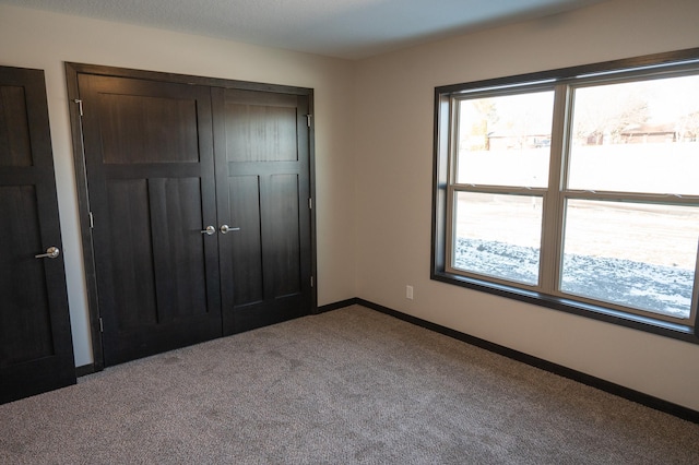 unfurnished bedroom featuring a closet and carpet