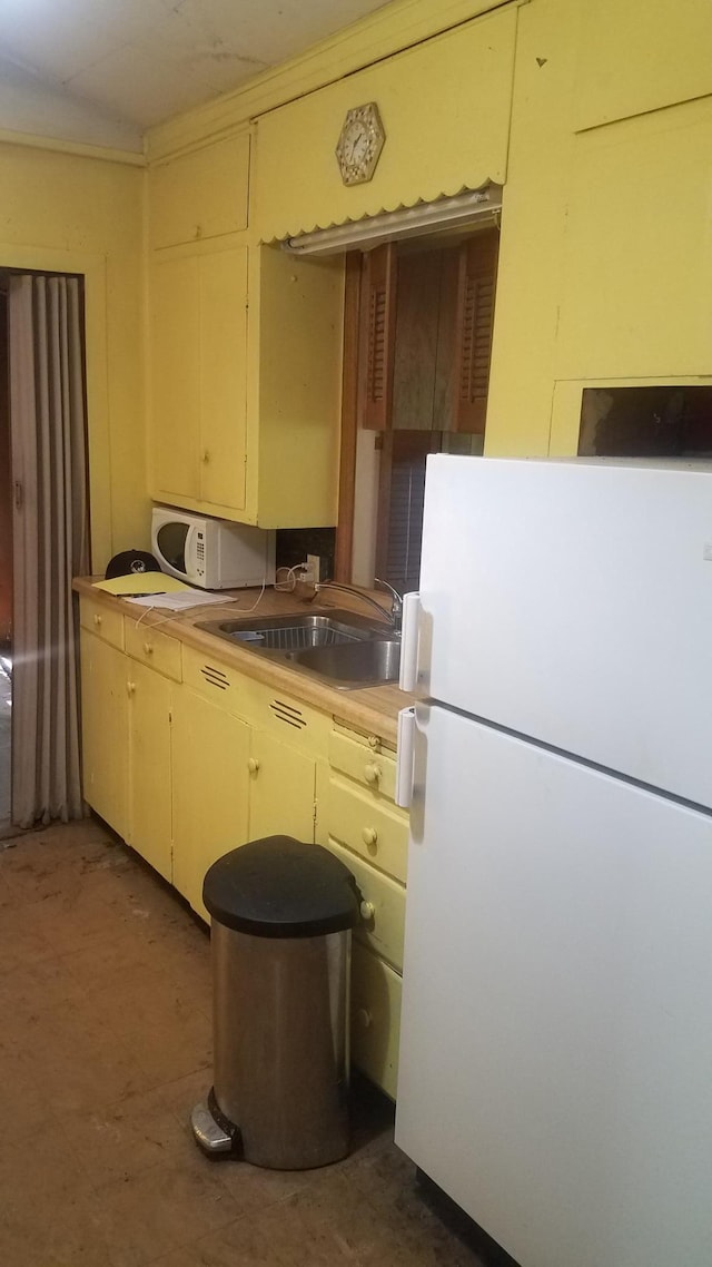 kitchen featuring white appliances and sink