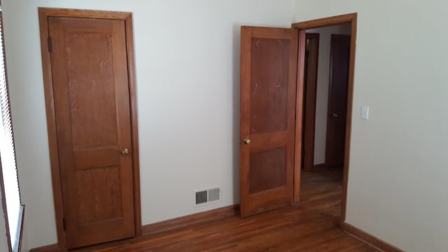 unfurnished bedroom featuring dark wood-type flooring