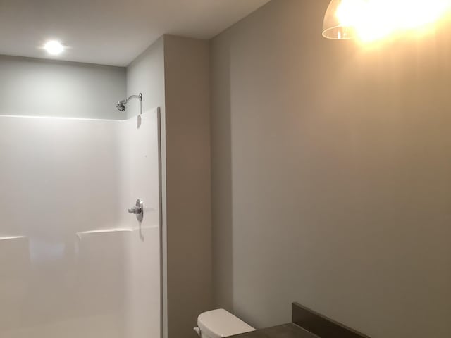 bathroom featuring toilet and a shower