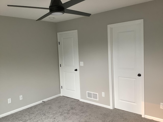 unfurnished bedroom featuring light carpet and ceiling fan