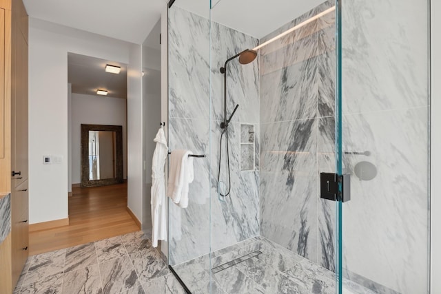 bathroom with walk in shower and wood-type flooring