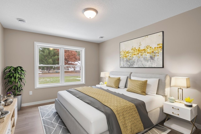 bedroom featuring wood-type flooring and a textured ceiling