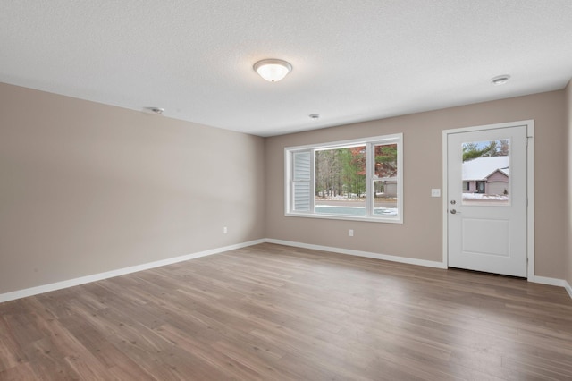 foyer with wood-type flooring and a textured ceiling