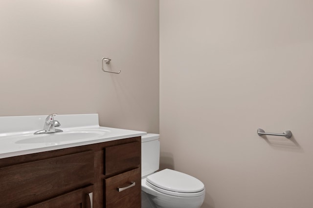 bathroom featuring toilet and vanity