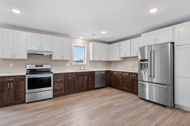 kitchen featuring light wood-type flooring, sink, dark brown cabinets, and stainless steel appliances