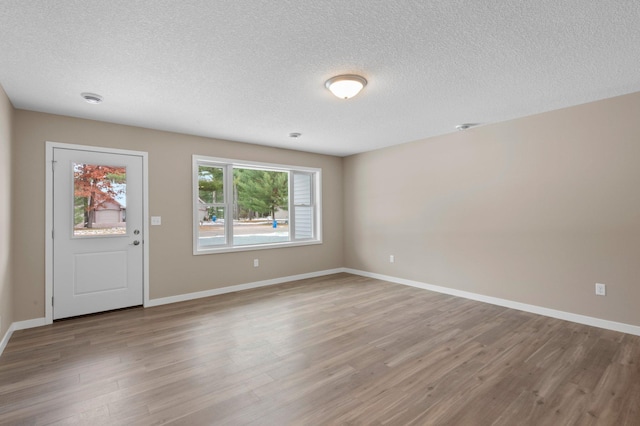 interior space with light hardwood / wood-style floors and a textured ceiling