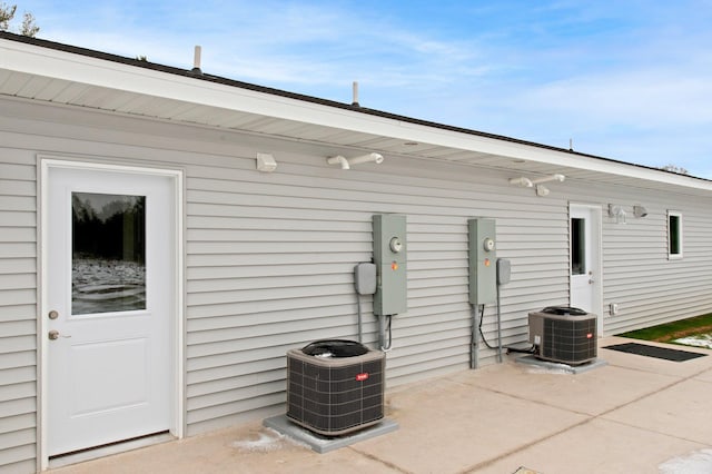 back of house featuring central air condition unit and a patio