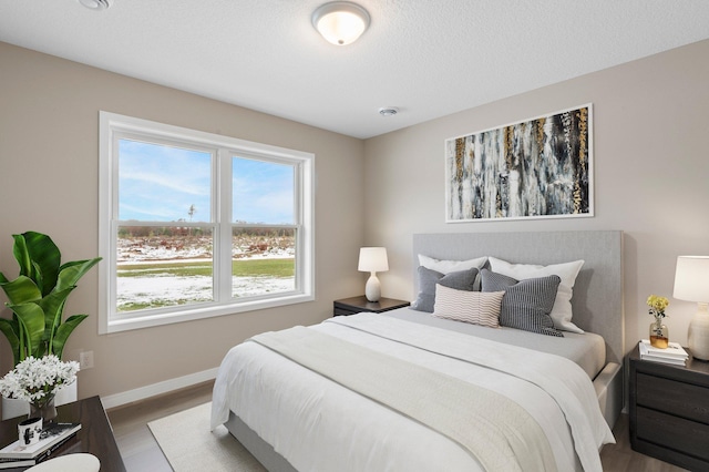 bedroom featuring hardwood / wood-style floors and a textured ceiling