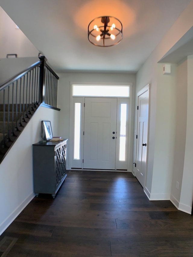 foyer featuring a notable chandelier and dark hardwood / wood-style floors