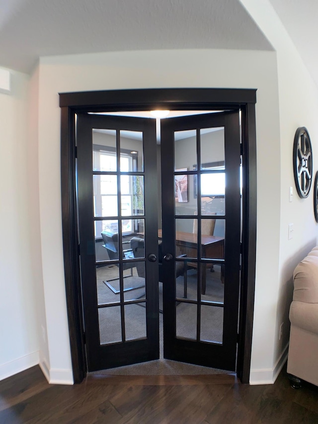 entryway with dark hardwood / wood-style floors and french doors