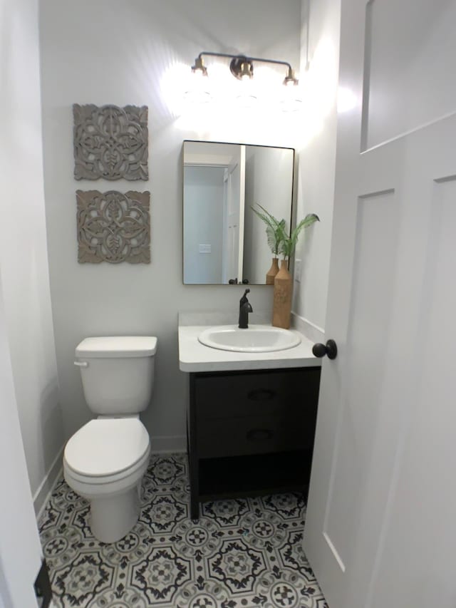 bathroom with tile patterned floors, vanity, and toilet