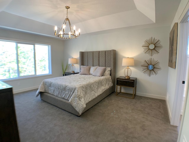 carpeted bedroom with a raised ceiling and an inviting chandelier