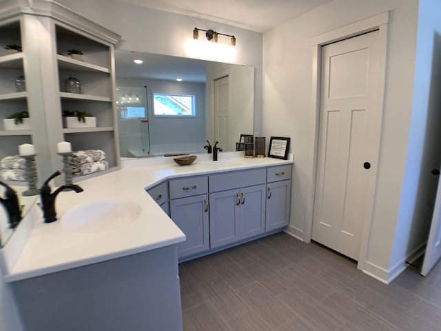 bathroom featuring hardwood / wood-style flooring, vanity, and an enclosed shower