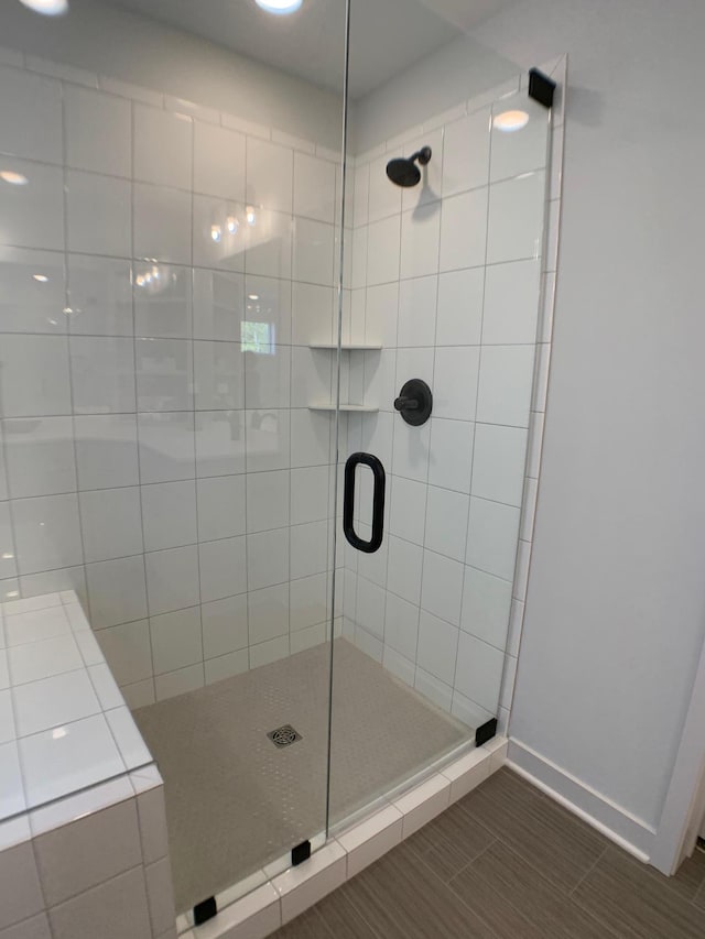 bathroom featuring a shower with door and tile patterned floors