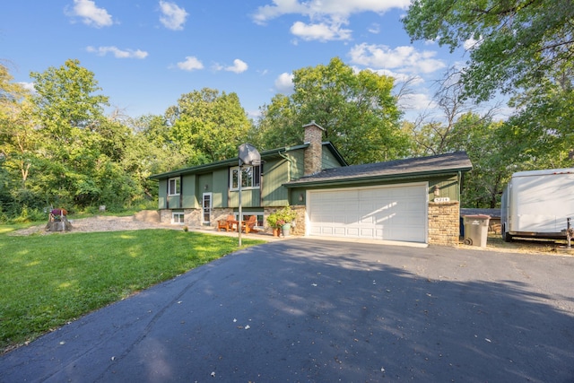 view of front of home with a front lawn and a garage