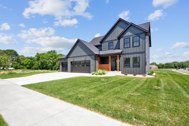 view of front of home with a front yard and a garage