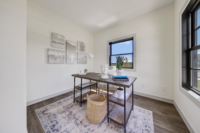 office with plenty of natural light and dark hardwood / wood-style floors