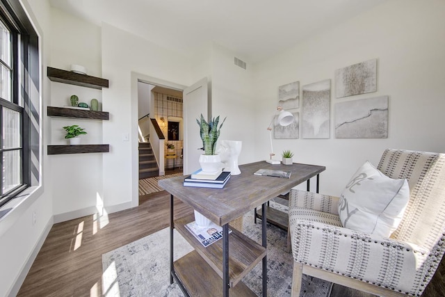 home office featuring dark hardwood / wood-style floors and a healthy amount of sunlight