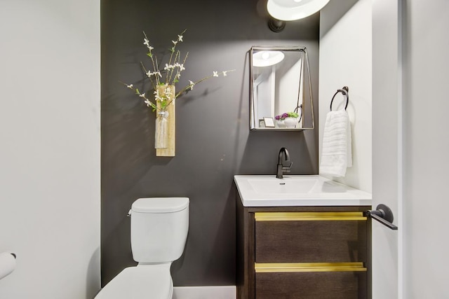 bathroom featuring toilet and vanity