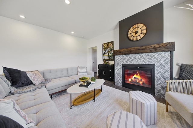 living room featuring a tiled fireplace and hardwood / wood-style floors