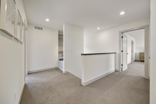 empty room featuring light colored carpet